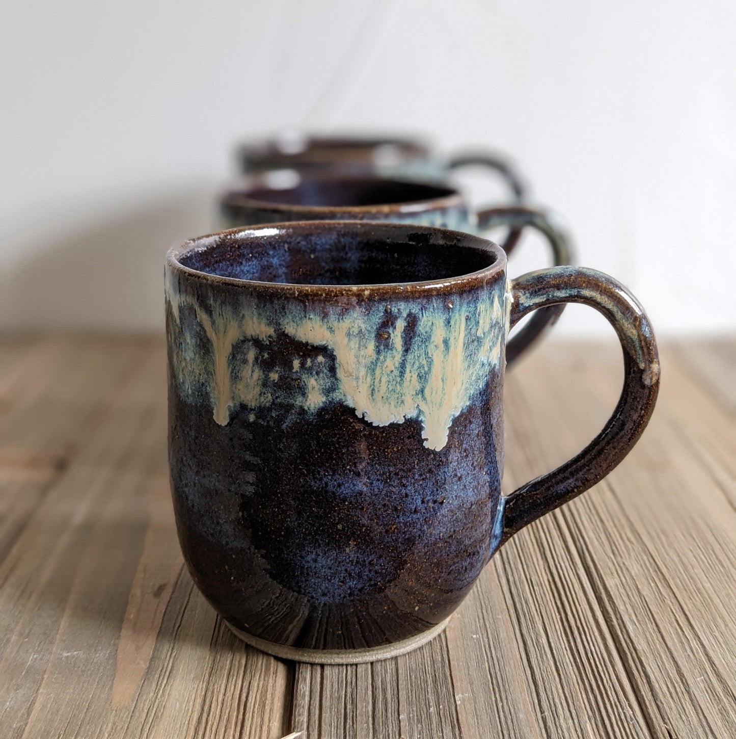 Brown Mug with multi-color drip.