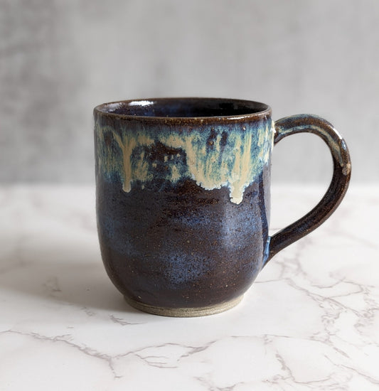 Brown Mug with multi-color drip.